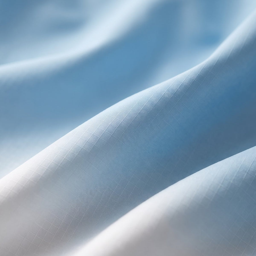 Close-up of soft ice-blue matte ripstop fabric in gentle folds